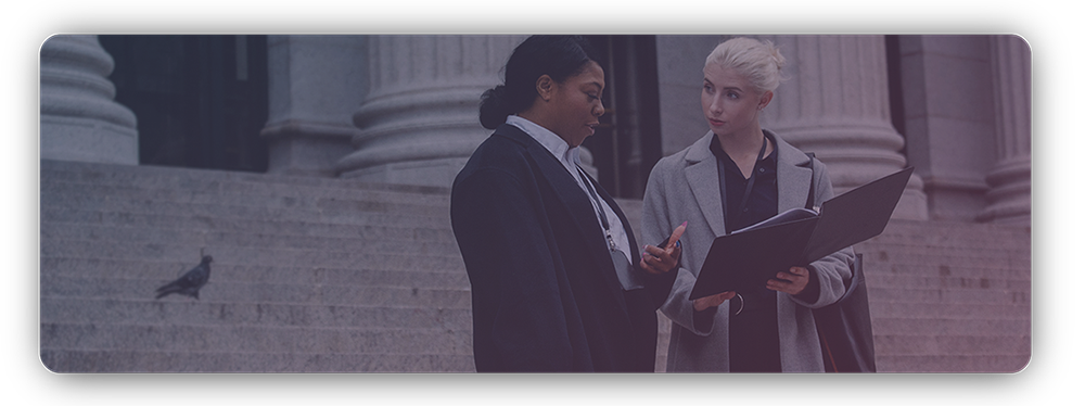 Woman and female lawyer talking outside of a courthouse